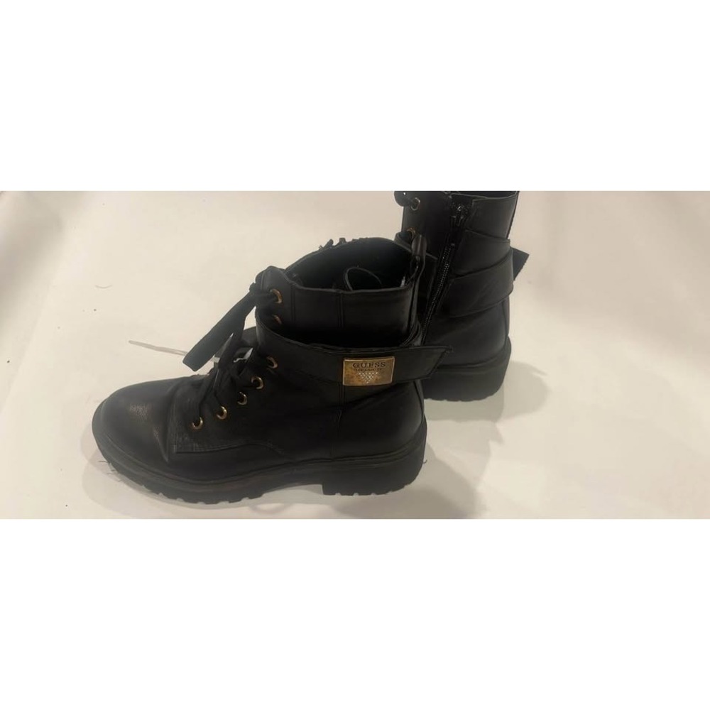 Stylish black Guess combat boots. Boots have lace-up front with gold eyelets.